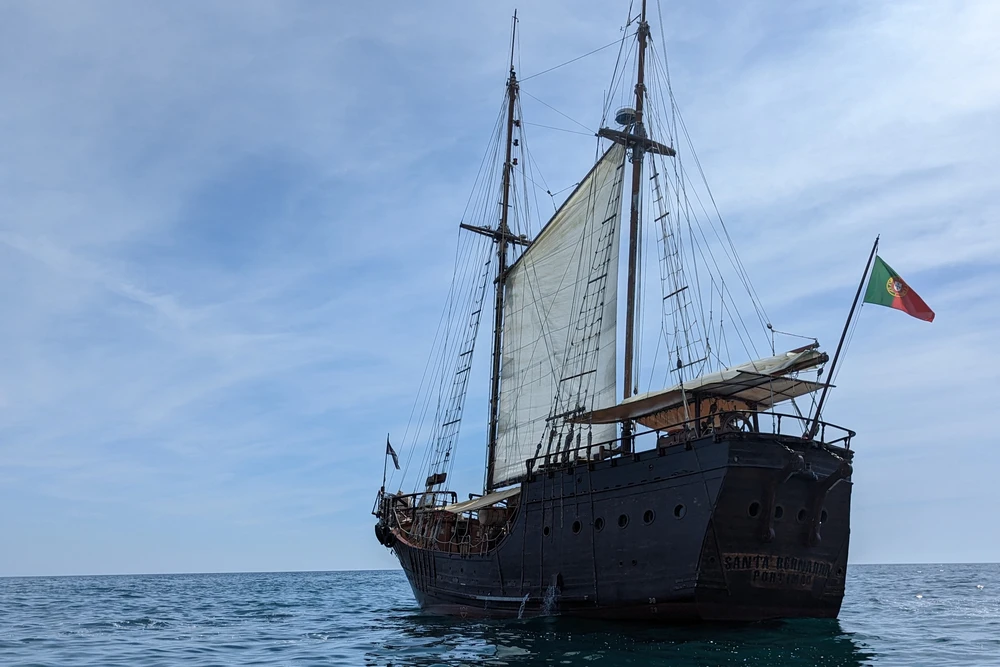 Traditional Portuguese sailing ship used for Benagil cave tours departing from Portimão, cruising on the Algarve coast.