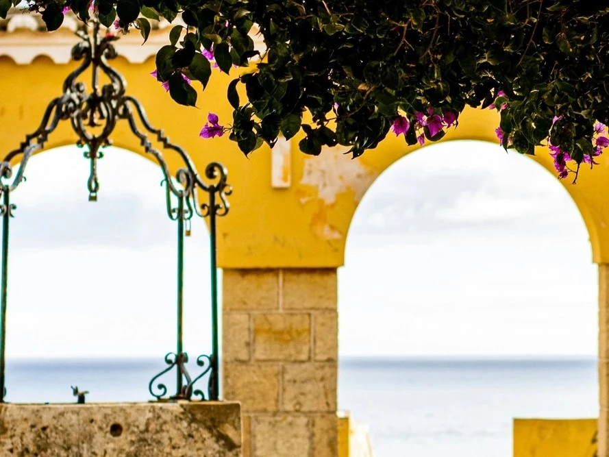Decorative ironwork and bougainvillea at Fort of Santa Catarina overlooking the sea in Portimão, Portugal