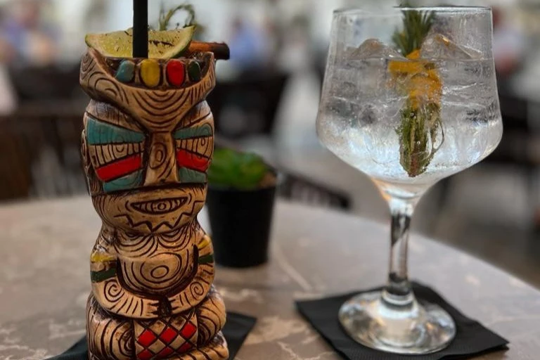 A refreshing tiki cocktail and a gin and tonic drink served at Arcada Cocktail Club in Tavira.
