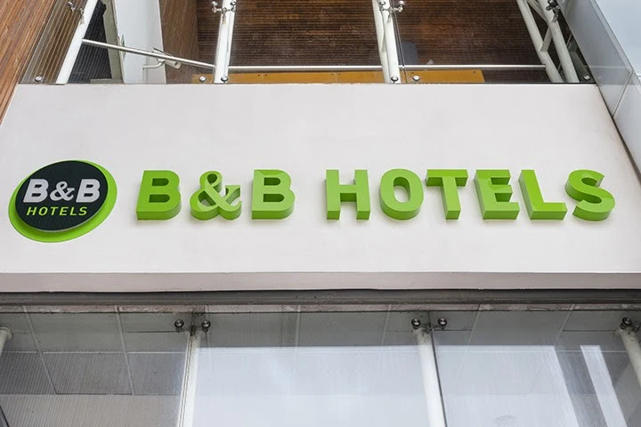 Close-up of the B&B HOTELS logo and signage on the exterior of the hotel building in Olhao, Portugal.