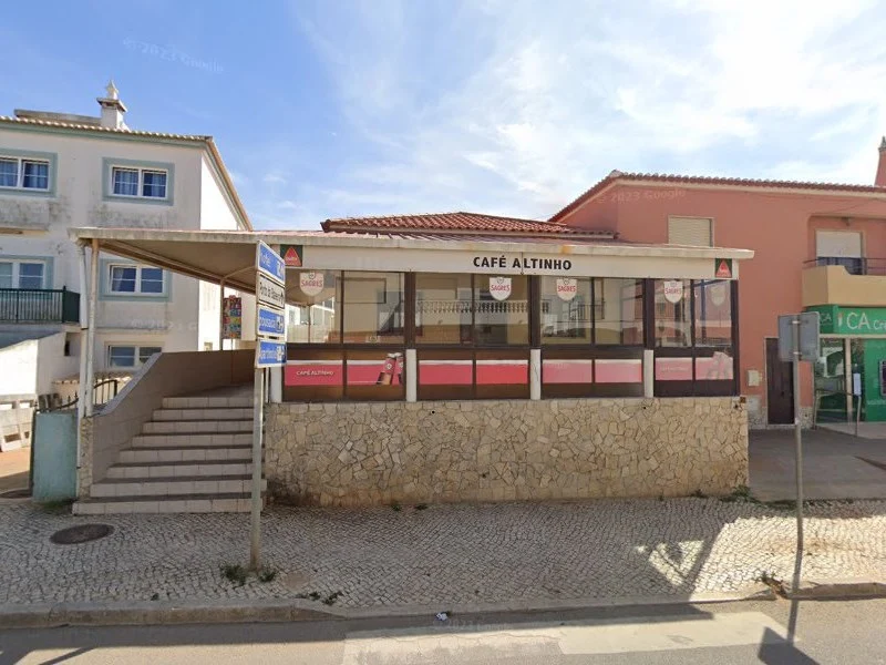 The street-front view of Café Altinho in Sagres, a local spot with a raised and covered outdoor patio area.