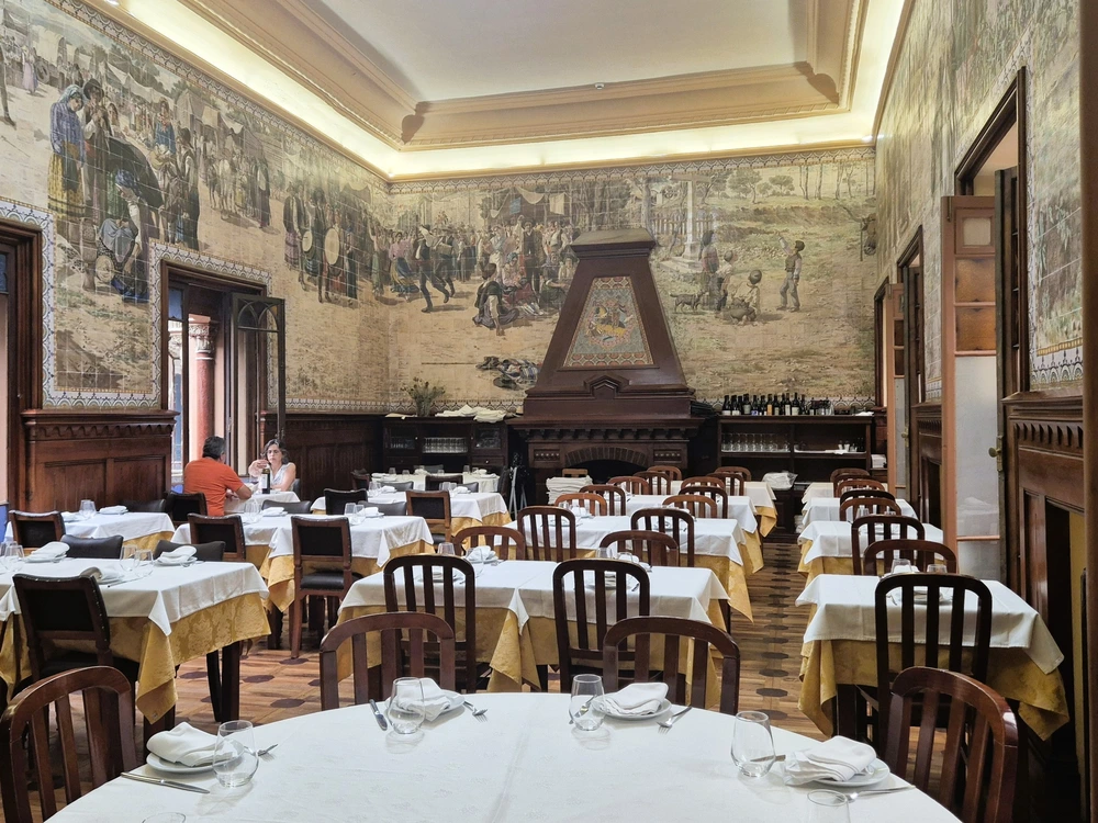 The elegant and traditional dining room of Casa do Alentejo restaurant in Lisbon, featuring beautiful, large-scale tile murals (azulejos) on the walls.