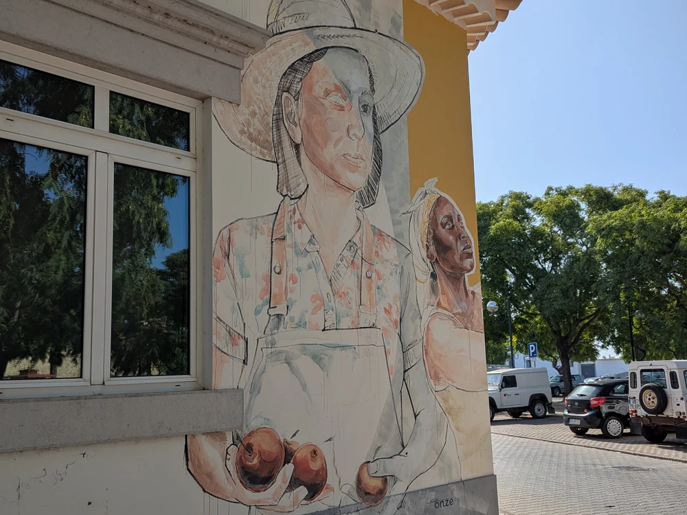 A striking public mural in Faro depicting local women, adding a touch of modern art to the city's streets.