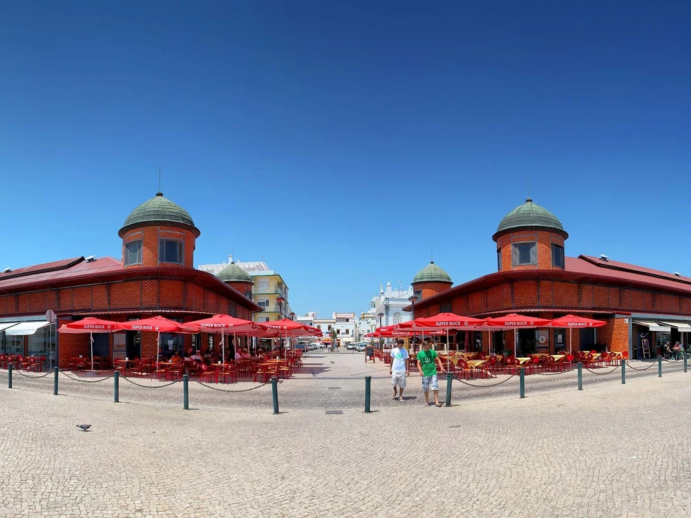 Sunny day at the waterfront Municipal Markets in Olhão, with their famous red-brick buildings and green domes.