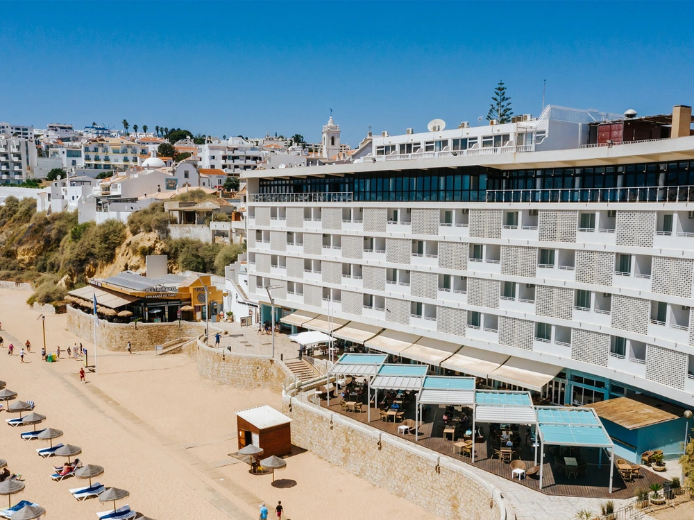 The beachfront Hotel Sol e Mar in Albufeira, with its guest balconies and terrace restaurant overlooking the sandy Praia do Túnel.