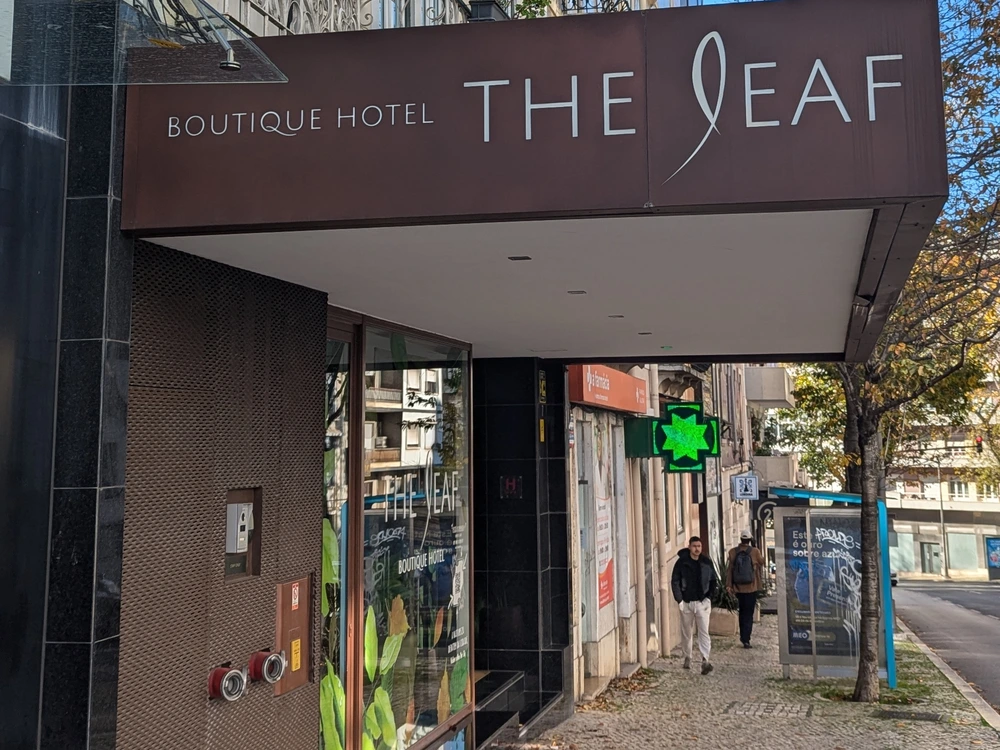 The modern and sleek entrance to The Leaf Boutique Hotel on a city street in Lisbon, Portugal.