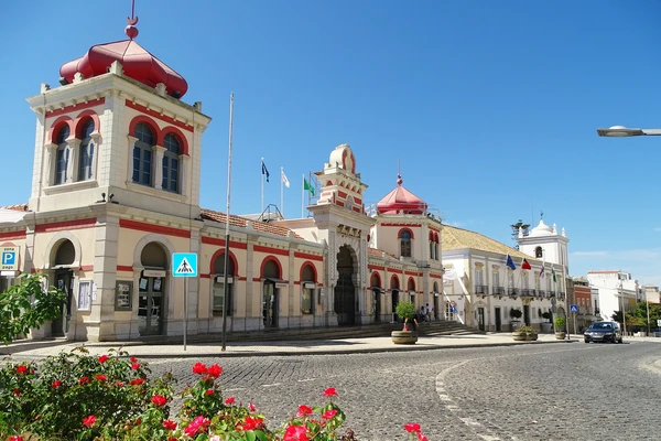Front view of the iconic Loulé Municipal Market (Mercado Municipal de Loulé) in Portugal, highlighting its intricate red-and-white facade and towers.