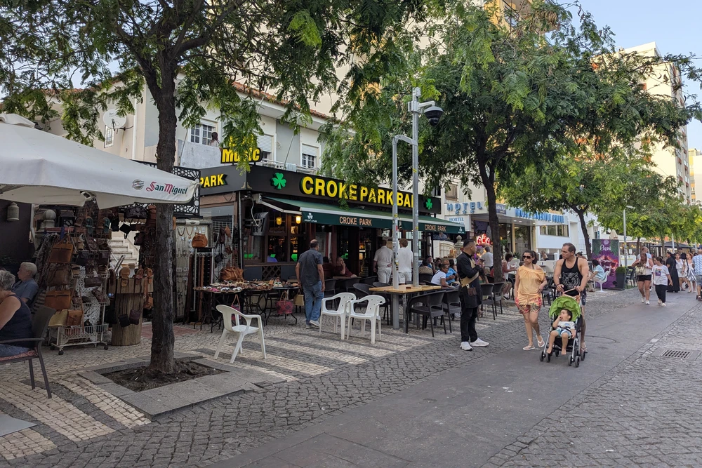 Croke Park Irish bar in Praia da Rocha, Portimão, with outdoor seating and a lively crowd on the main walking street