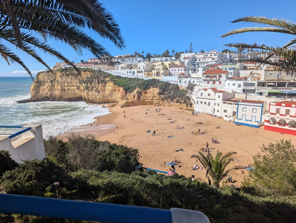 Panoramic view of Praia do Carvoeiro beach with its iconic white houses and golden cliffs, perfect for a Tavira day trip.